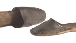 A photograph of a pair 19th-century wooden clog shoes