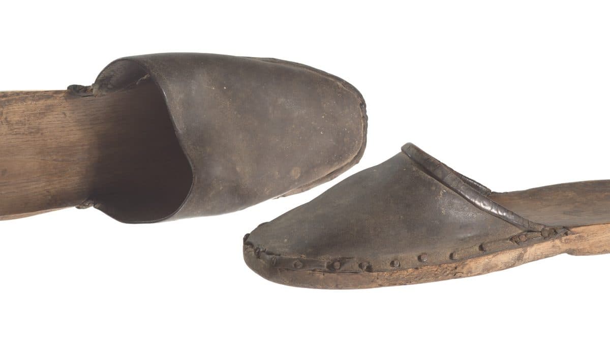 A photograph of a pair 19th-century wooden clog shoes